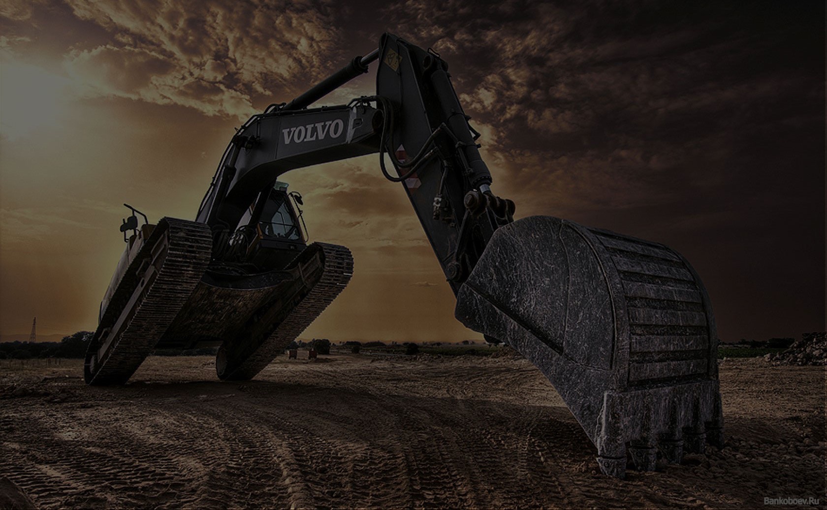 Excavator working a Sydney demolition site at dusk
